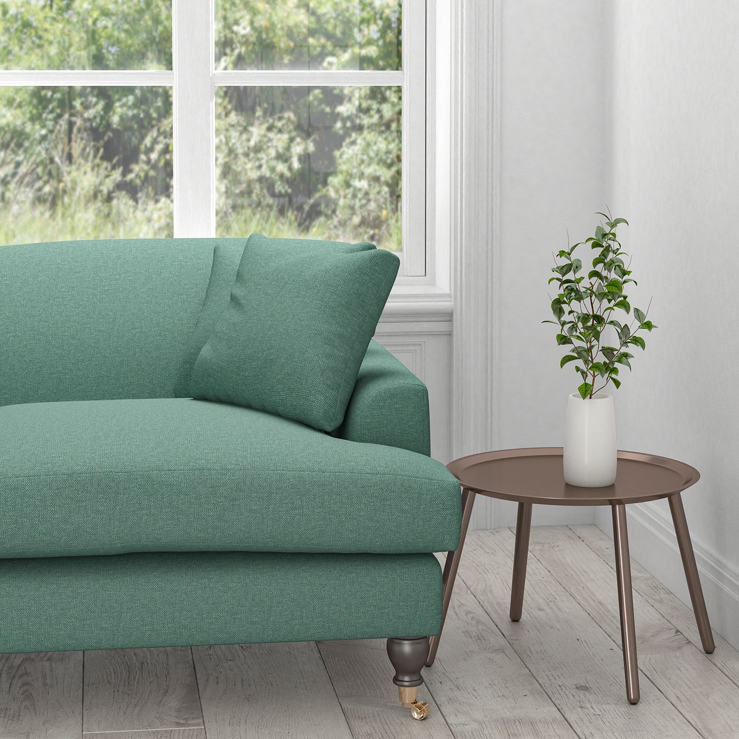 Sofa upholstered in a plain teal cotton fabric