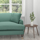 Sofa upholstered in a plain teal cotton fabric