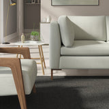 Living room with a contemporary sofa upholstered in a blue semi-plain Scandi-style upholstery fabric