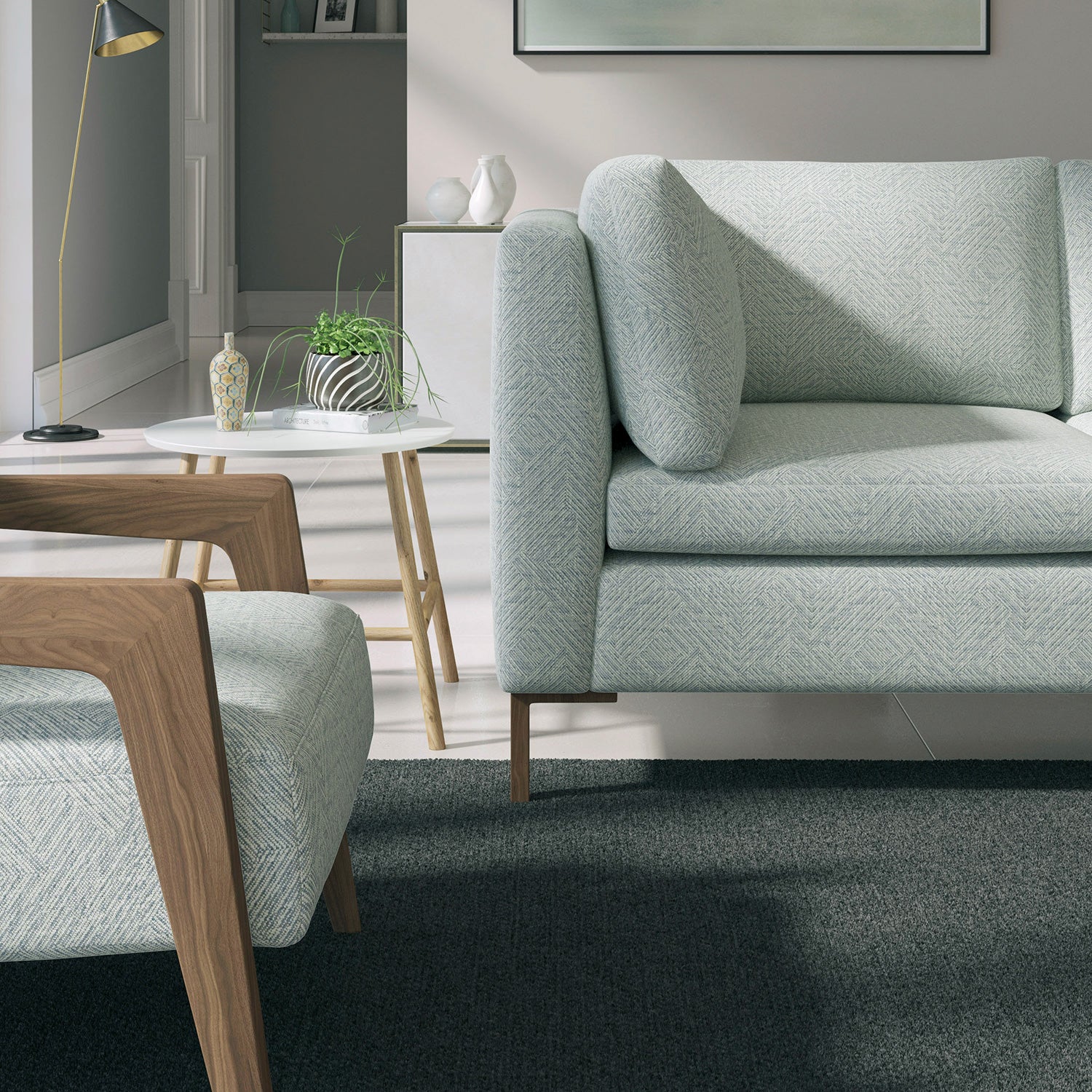 Living room with a contemporary sofa upholstered in a dark blue semi-plain Scandi-style upholstery fabric
