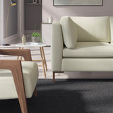 Living room with a contemporary sofa upholstered in a beige semi-plain Scandi-style upholstery fabric