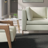 Living room with a contemporary sofa upholstered in a grey semi-plain Scandi-style upholstery fabric