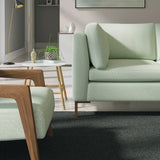 Living room with a contemporary sofa upholstered in a aqua semi-plain Scandi-style upholstery fabric