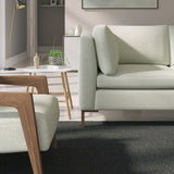 Living room with a contemporary sofa upholstered in a light blue semi-plain Scandi-style upholstery fabric