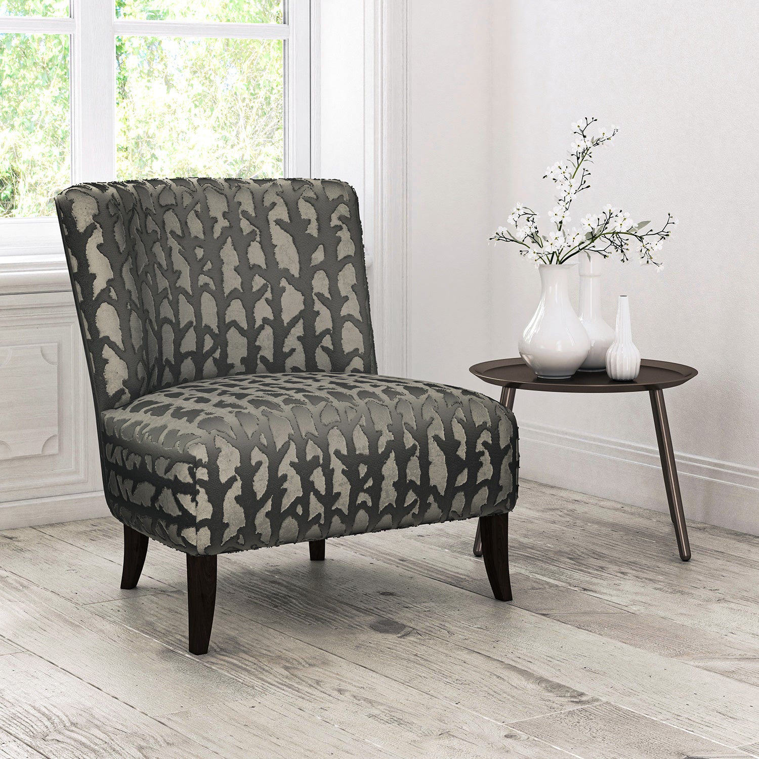 Chair upholstered in a dark neutral velvet upholstery fabric with abstract branch design