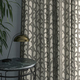 Curtain in luxury dark neutral velvet fabric with abstract branch design 