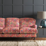 Velvet sofa upholstered in a pink and multicoloured velvet fabric with carpet design and stain resistant finish