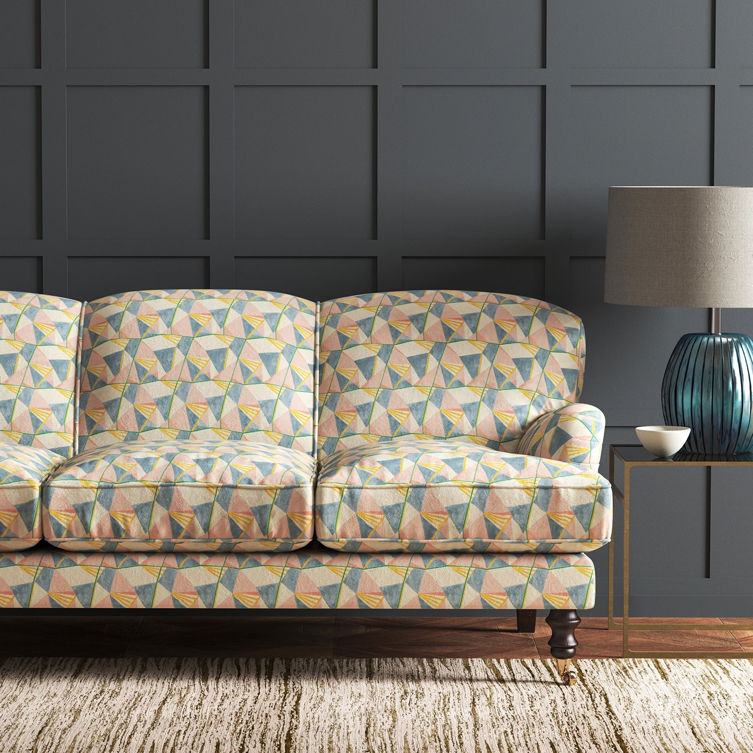 Velvet sofa upholstered in a pastel coloured velvet fabric with geometric design and stain resistant finish