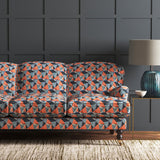 Velvet sofa upholstered in a blue and orange velvet fabric with geometric design and stain resistant finish