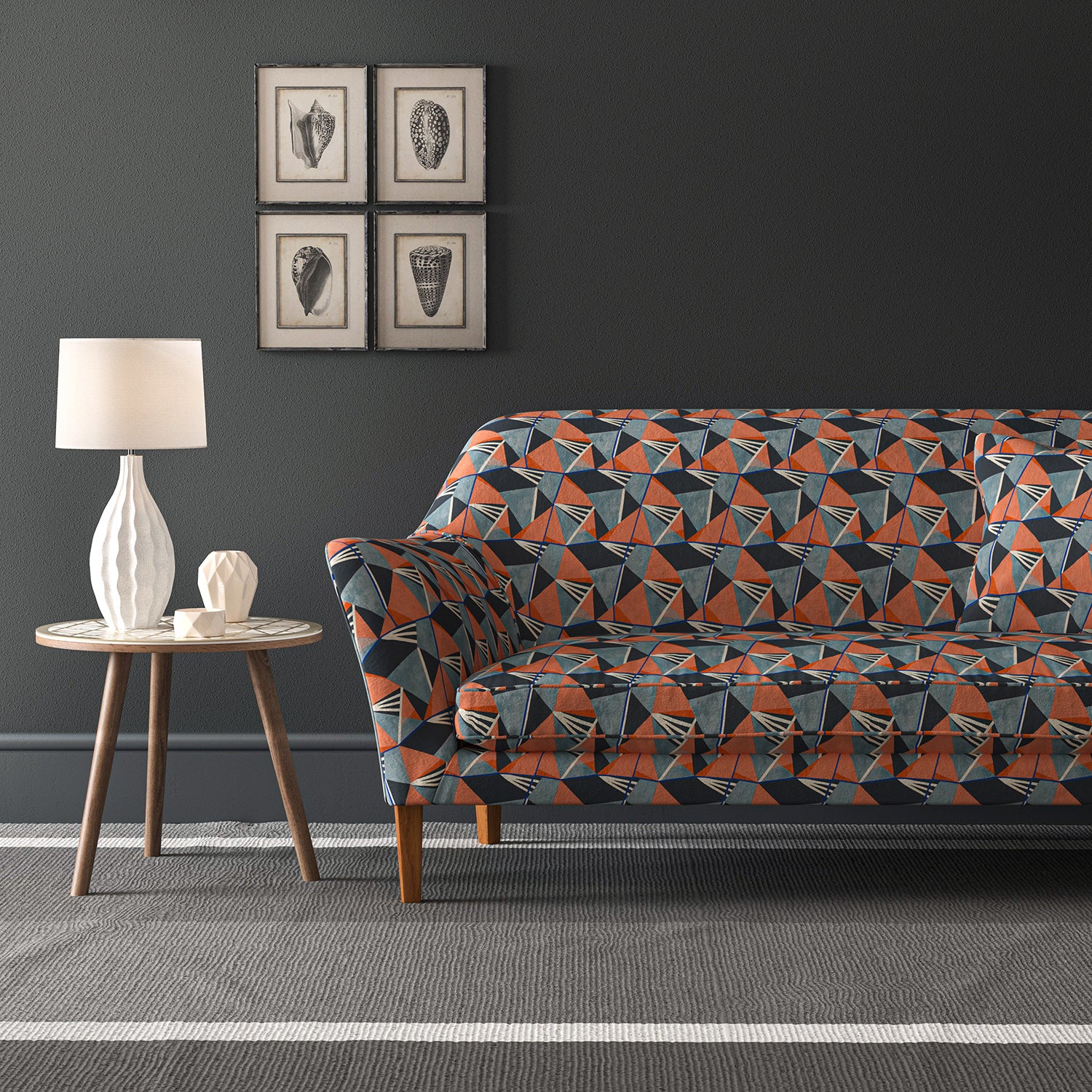 Velvet sofa upholstered in a blue and orange velvet fabric with geometric design and stain resistant finish