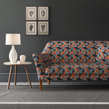 Velvet sofa upholstered in a blue and orange velvet fabric with geometric design and stain resistant finish