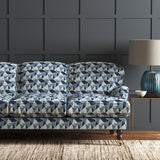 Velvet sofa upholstered in a blue velvet fabric with geometric design and stain resistant finish
