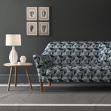 Velvet sofa upholstered in a blue velvet fabric with geometric design and stain resistant finish