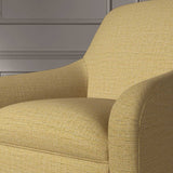 Close up of a chair covered in a woven fabric in a herringbone design in Saffron