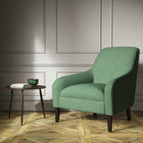 A green woven fabric on an armchair.