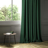 A green woven fabric on an armchair.