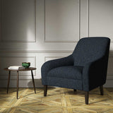 A blue woven fabric on an armchair.