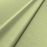 Fabric swatch of a plain bright green weave fabric for upholstery