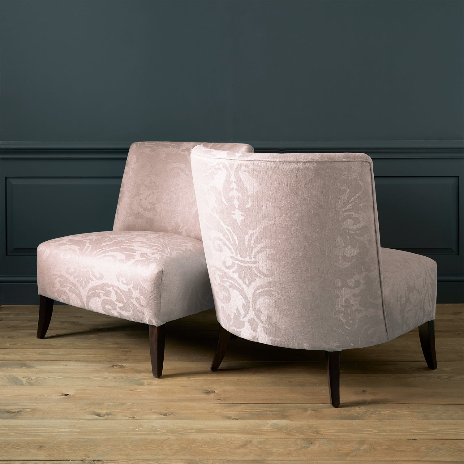 Armchairs in a a contemporary damask fabric in a light pink colour.
