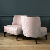 Armchairs in a a contemporary damask fabric in a light pink colour.