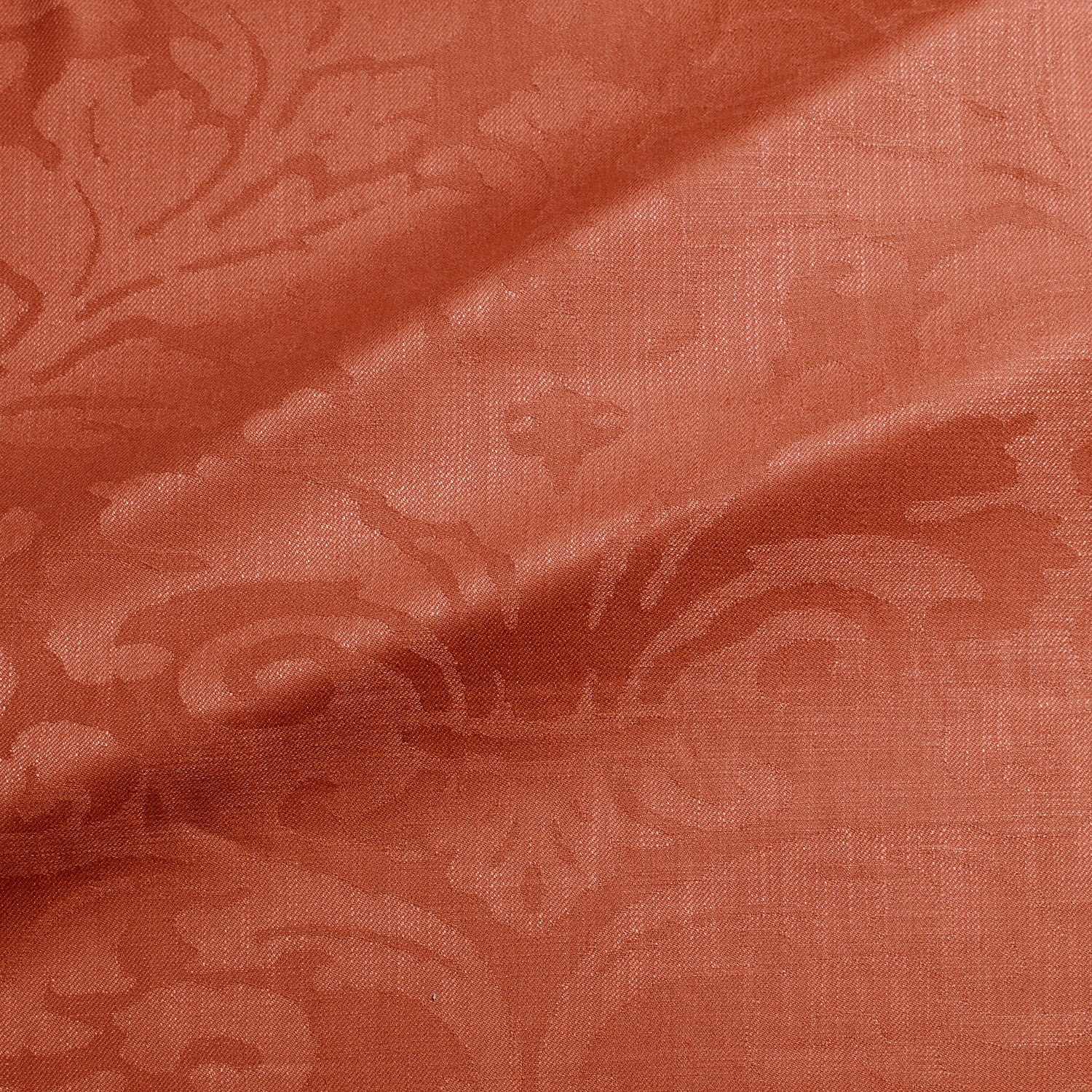 Fabric swatch of a contemporary damask fabric in a red colour for upholstery and curtains.