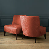 Armchairs in a contemporary damask fabric in a red colour.