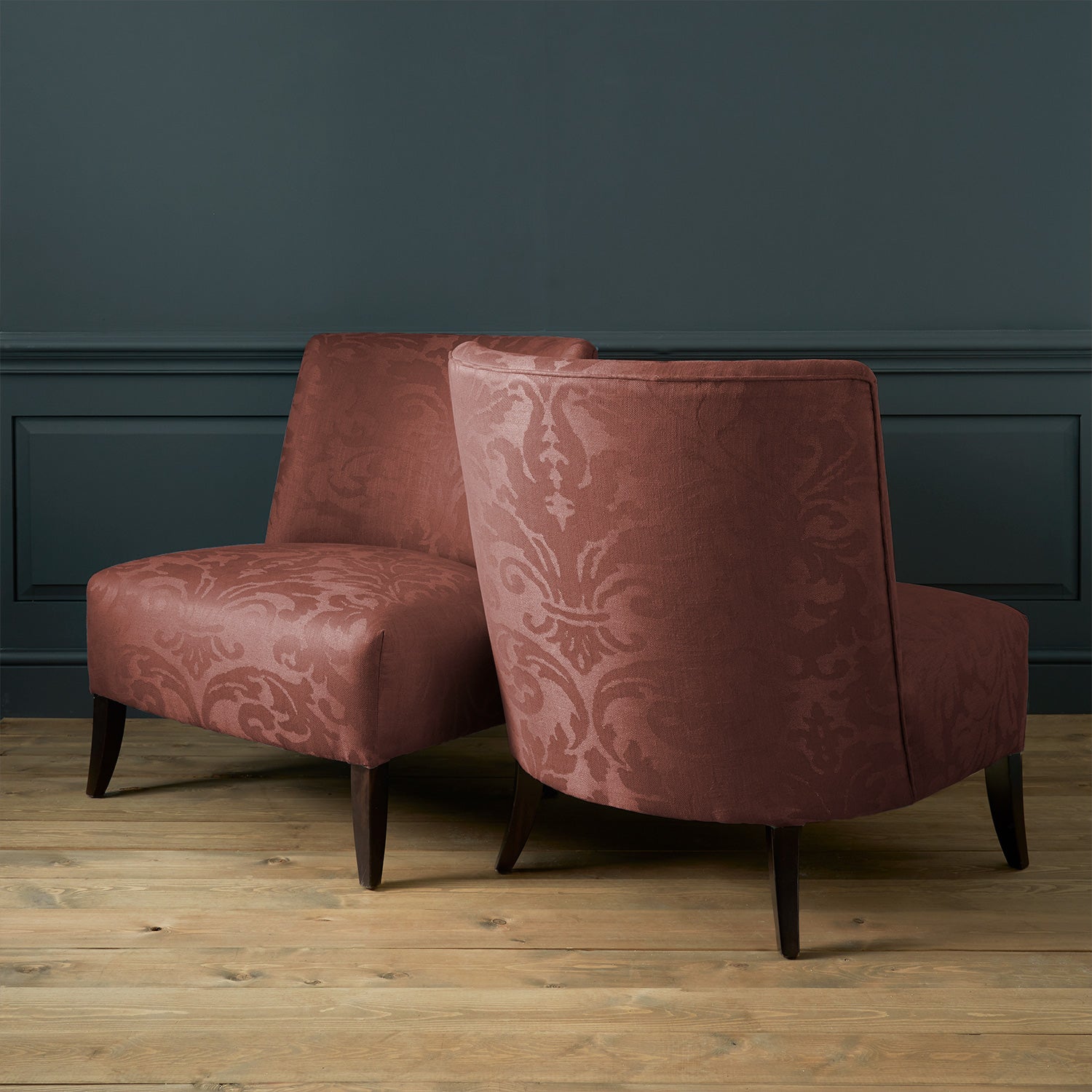 Armchairs in a contemporary damask fabric in a deep berry colour.