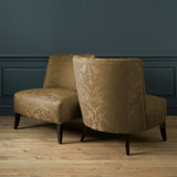 Armchairs in a contemporary damask fabric in a brown colour.
