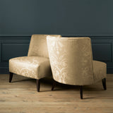 Armchairs in a contemporary damask fabric with light gold colour.
