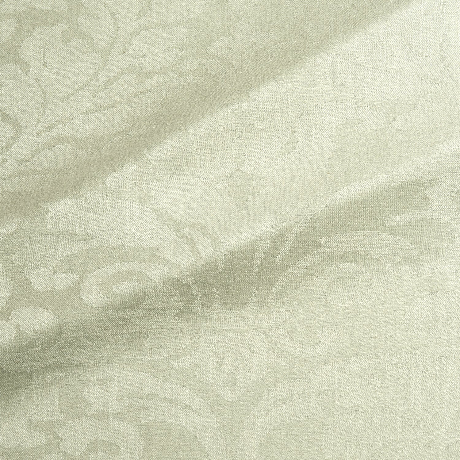 Fabric swatch of a contemporary damask fabric in a light green colour for upholstery and curtains.