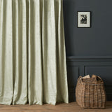 Curtains in a contemporary damask fabric with light green colours.