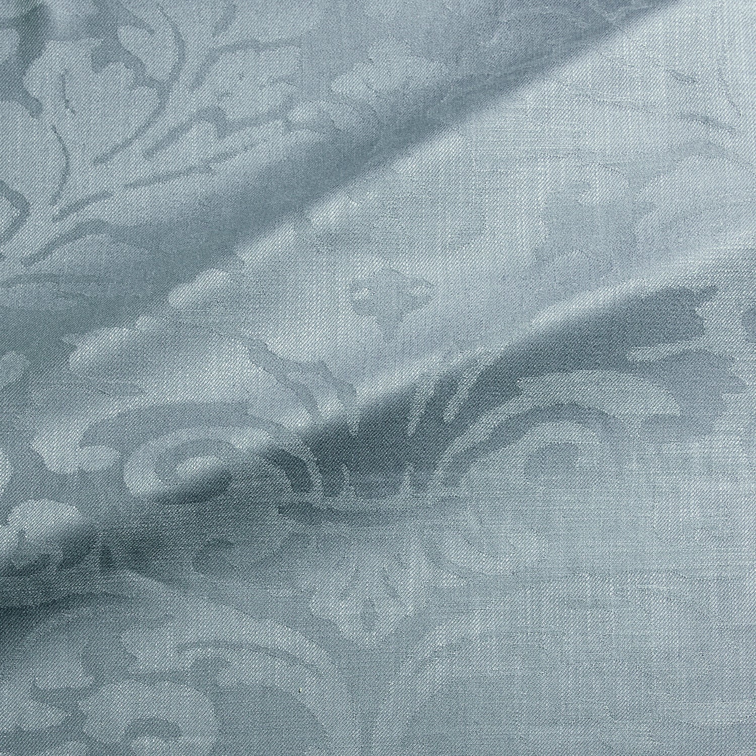 Fabric swatch of a contemporary damask fabric in a blue colour for upholstery and curtains.
