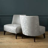 Armchairs in a contemporary damask fabric with light cream colour.