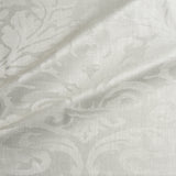 Fabric swatch of a contemporary damask fabric in a cream colour for upholstery and curtains.