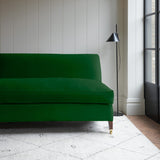 Green velvet upholstery fabric on a classic sofa.