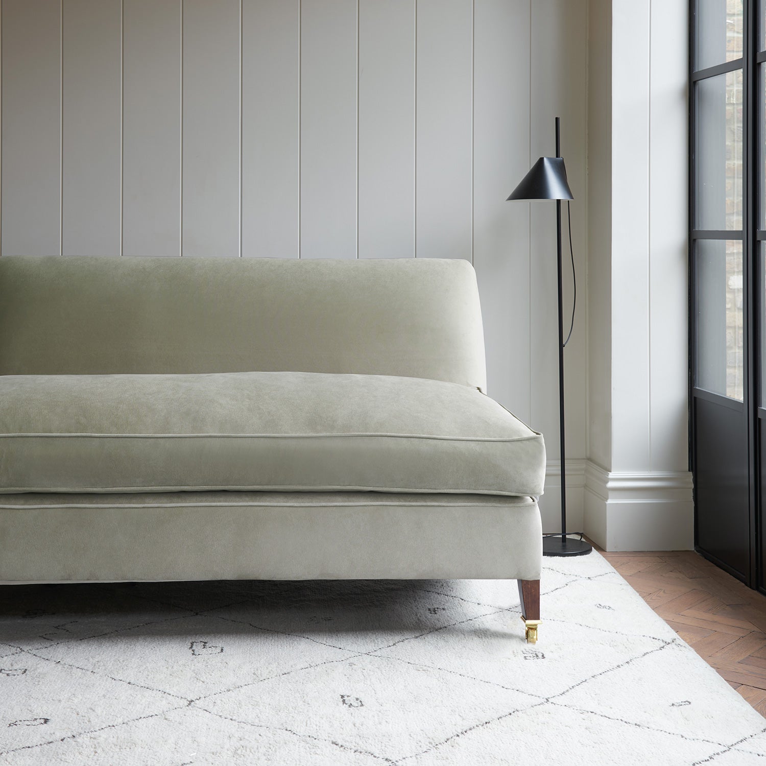 Neutral velvet upholstery fabric on a classic sofa. 