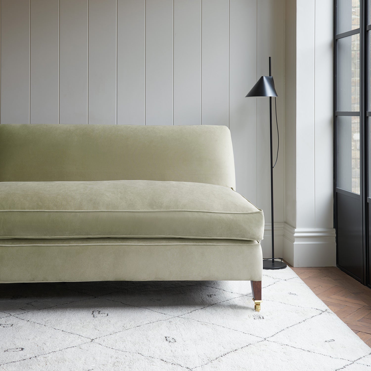 Neutral velvet upholstery fabric on a classic sofa.