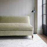 Neutral velvet upholstery fabric on a classic sofa.