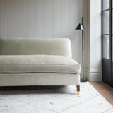Grey velvet upholstery fabric on a classic sofa.