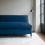Blue velvet upholstery fabric on a classic sofa.