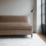 Brown velvet upholstery fabric on a classic sofa.