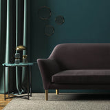 Sofa covered in a brown velvet upholstery fabric 