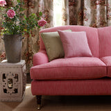 A pink stain resistant woven fabric on an armchair.