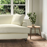 A cream stain resistant woven fabric on an armchair.