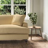A yellow stain resistant woven fabric on an armchair.