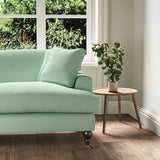 A green stain resistant woven fabric on an armchair.