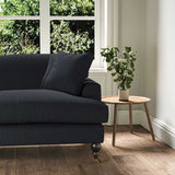 A navy stain resistant woven fabric on an armchair.