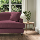 A purple stain resistant woven fabric on an armchair.