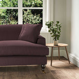 A purple stain resistant woven fabric on an armchair.