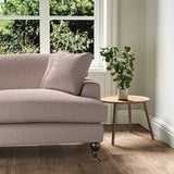 A pink stain resistant woven fabric on an armchair.